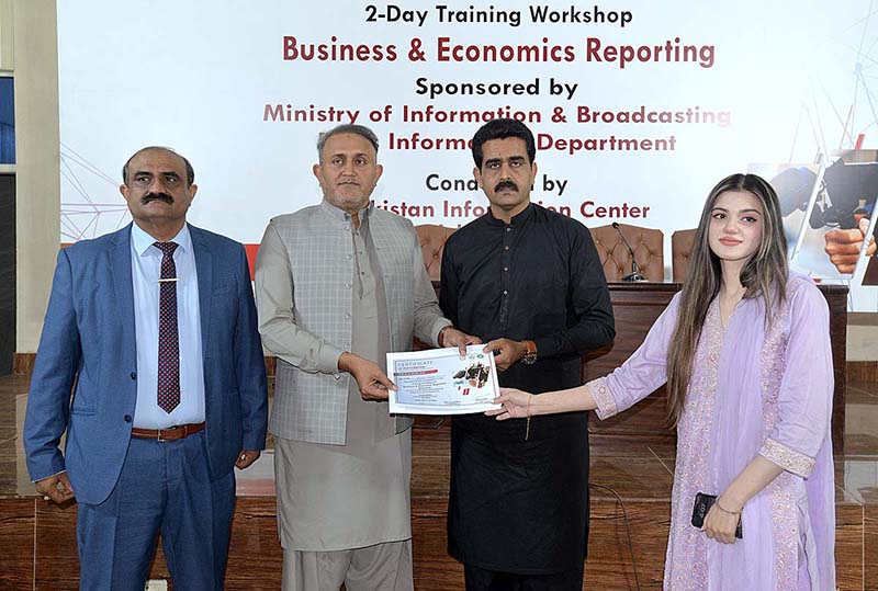 DG information Services Academy Saeed Ahmad Sheikh giving certificates to participant during 2-Day Training Workshop of Business & Economics Reporting at information Services Academy