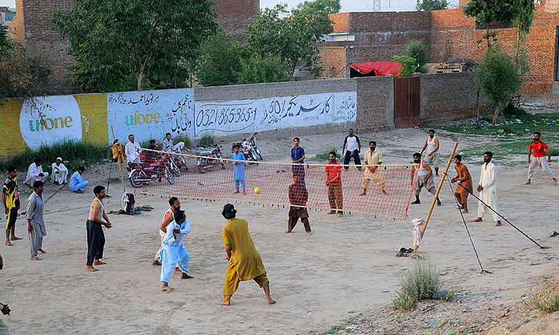 Youngsters playing volleyball in a local ground
