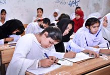 Students attempting question paper during their annual examination of SSC (Part-II) 10th class at Government Girls High School