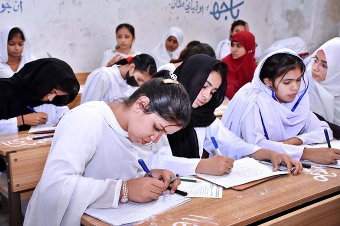 Students attempting question paper during their annual examination of SSC (Part-II) 10th class at Government Girls High School