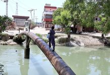 A youngster crossing the canal through water supply pipeline at Mirpurkhas Road