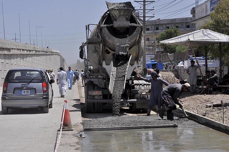 Labourers busy in construction work of IJP Road during development work in the city