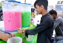 A vendor displaying the summer drink to attract the customers on his hand cart
