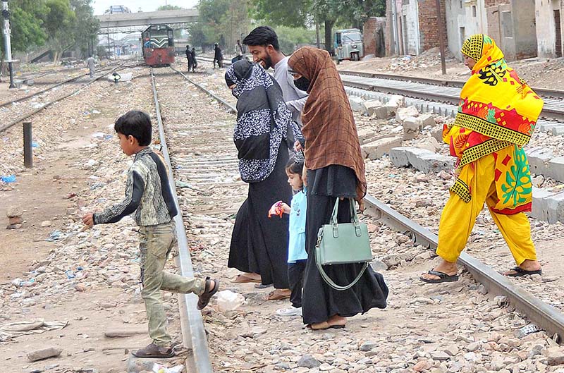 A family crossing railway track while train is approaching on the same track may cause any mishap