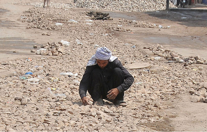 Labourer working during construction work of the road at Timber Market