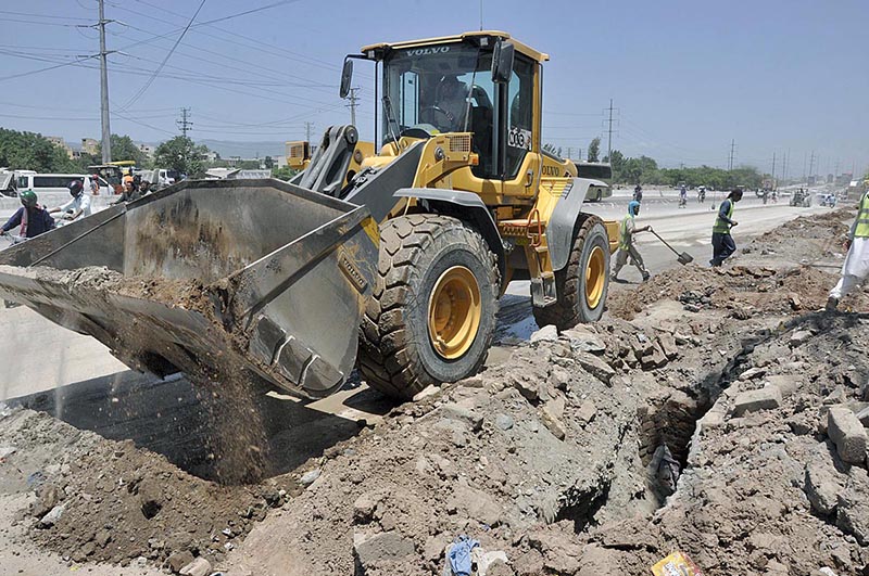 Labourers busy in construction work of IJP Road during development work in the city