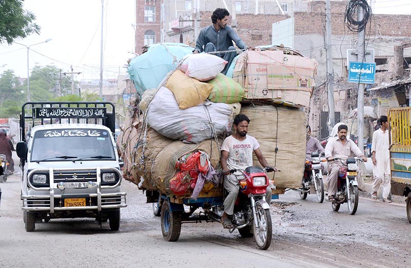 A Loader rickshaw driver on his way loaded with heavy scrap bags may cause any mishap and needs the attention of the concerned authorities