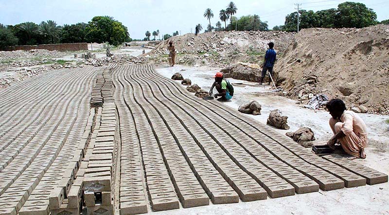 Labourers busy in preparing bricks at a local bricks kiln on the occasion of Solidarity Labor Day