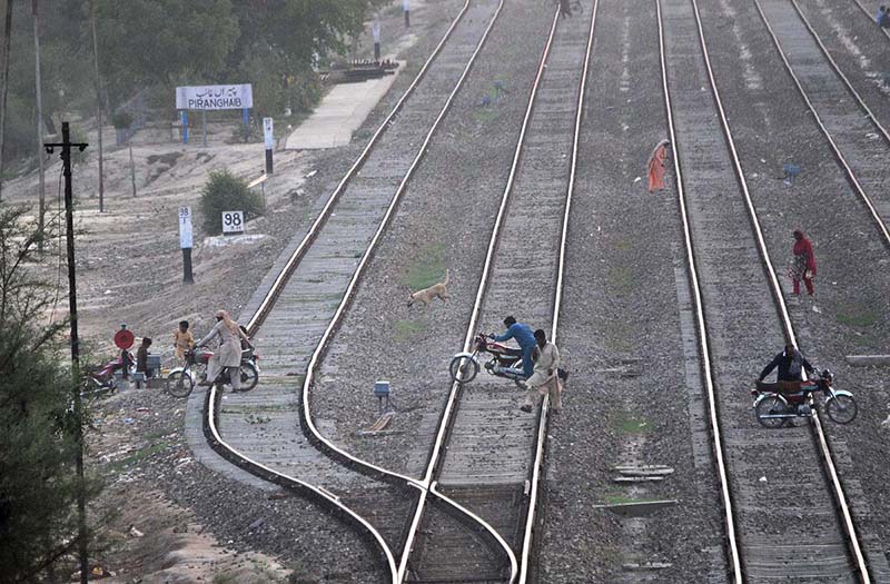 Motorcyclists crossing the railway track at Piran Ghaib railway station which may cause a serious accident