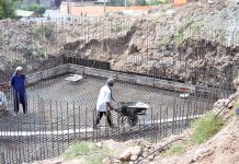 Labourers busy in construction work of water storage tank at Qasim