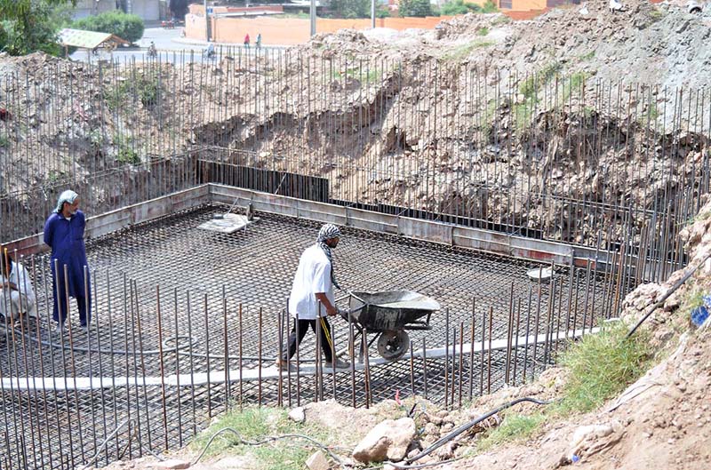 Labourers busy in construction work of water storage tank at Qasim