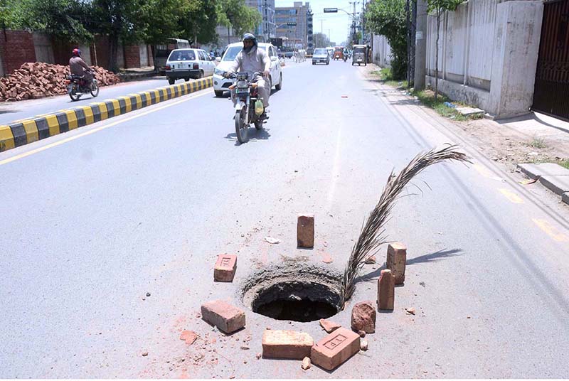 A view of an open manhole at High court road needs the attention of concerned authorities