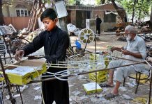 A PHA worker makes materials of decoration for canal and mall road