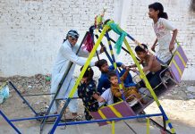 Children enjoying the swing at Latifabad