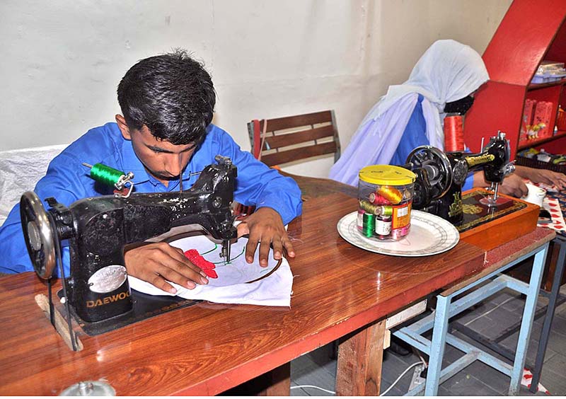 Special Students showing her skill work during fragrance of special Students an Art & vocational Exhibition of Students with Disabilities at University of Sargodha