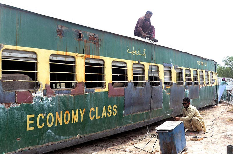 workers are diligently welding a train carriage with the purpose of transforming it into a functional and inviting hotel at Damdama