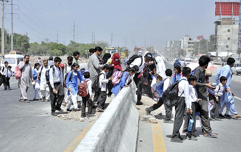 Hundreds of students daily cross the busy IJP Road due to unavailability of crossing space or pedestrian bridge, needs the attention of concerned authorities