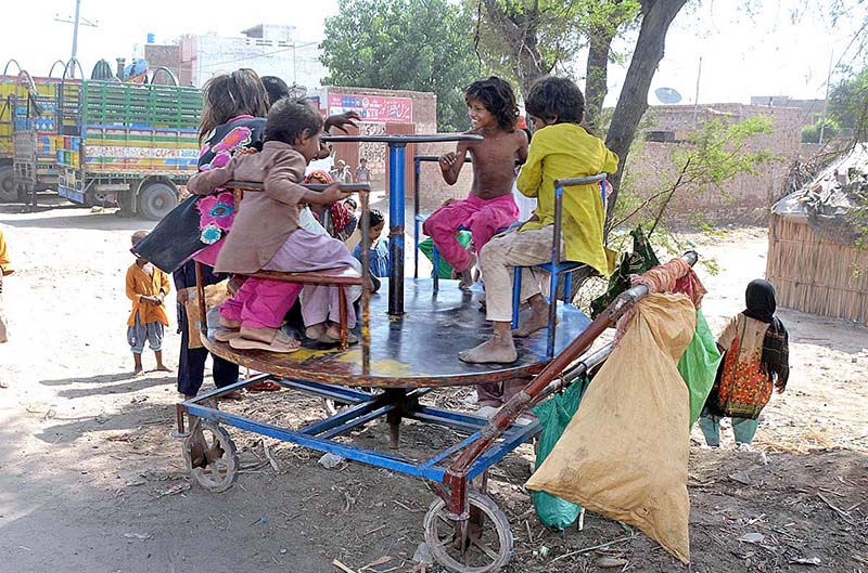 Gypsy children enjoying swing