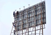 Laborers busy in maintenance of billboard at katchery chowk