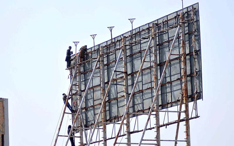 Laborers busy in maintenance of billboard at katchery chowk