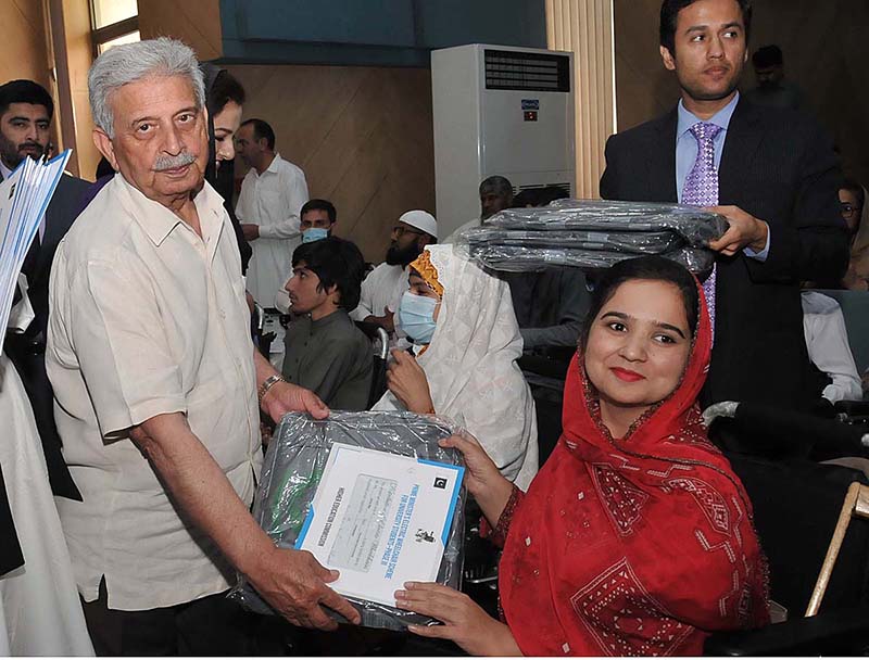 Federal Minister for Education & professional Training Rana Tanveer Hussain distributing wheelchairs to the participants of Prime Ministers Electric wheelchair Scheme for University Students: Distribution Ceremony - Phase 111 organized by Higher Education Commission at HEC