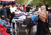 Peoples purchasing used clothes from a roadside vendor in Provincial Capital City