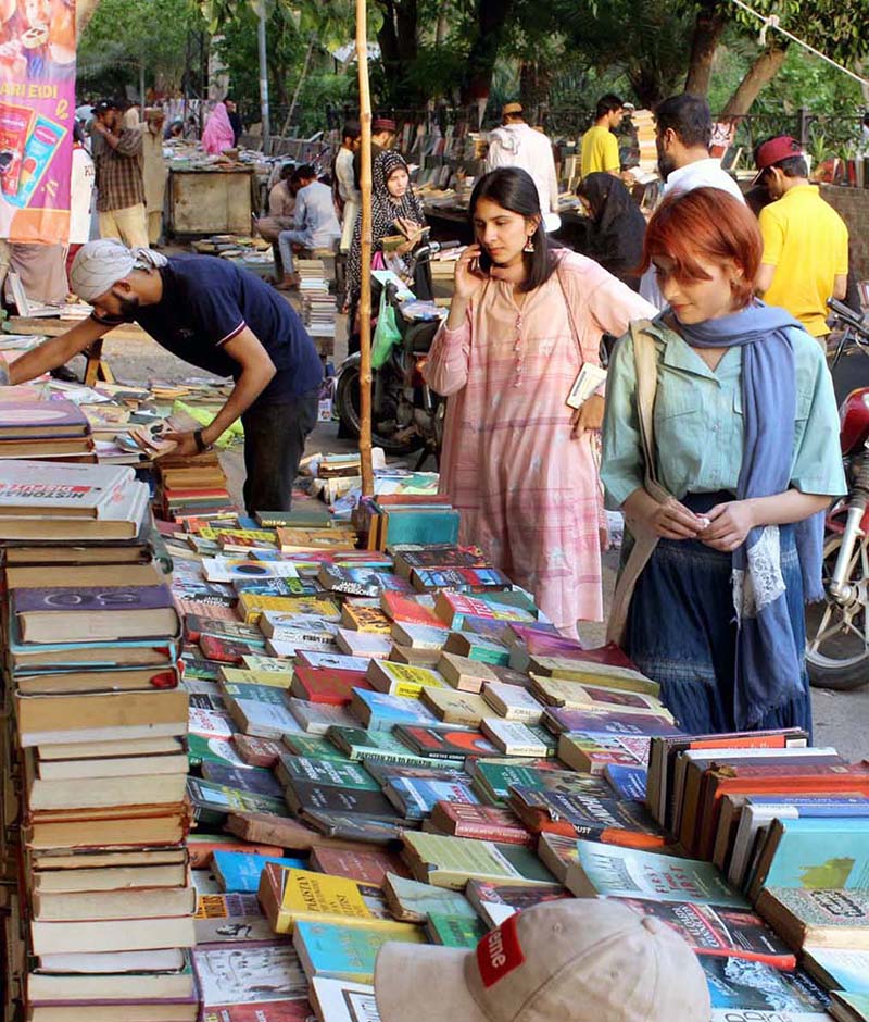 People busy in selecting and purchasing old books from roadside setup in Provincial Capital