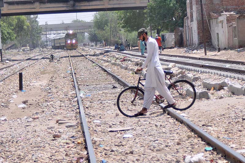 A cyclist crossing a rail track while a train coming on the same track may cause any mishap