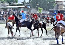 Players struggling to get hold on the ball during the polo match between Karakoram and NLI teams at Shahi polo ground