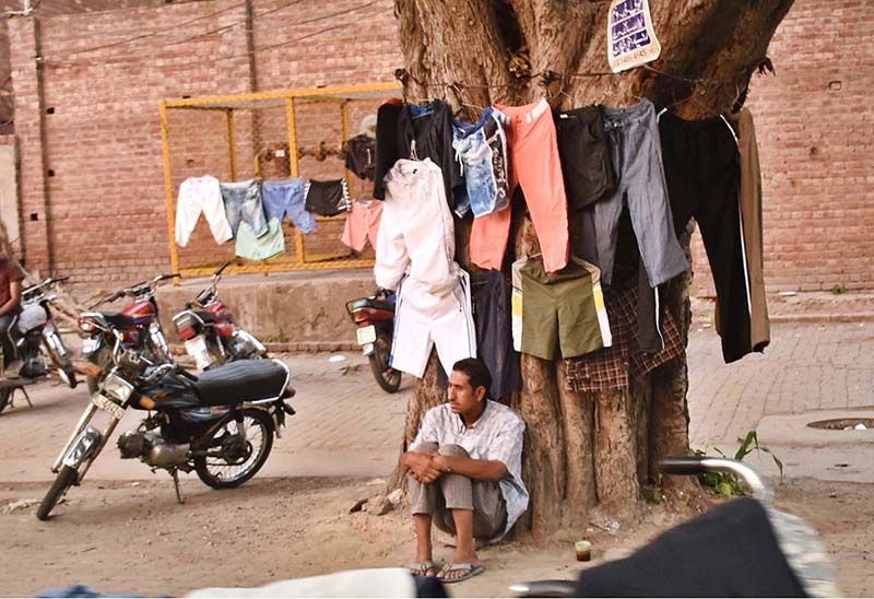 A vender waiting for the customers at his roadside setup in Provincial Capital City