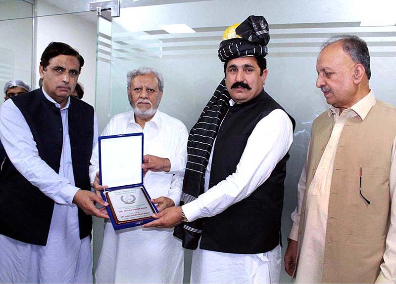 Special Assistant to Caretaker Chief Minister KP, Malik Meher Elahi presents a shield to the Federal Minister for Overseas Pakistanis & Human Resource Development Sajid Hussain Turi