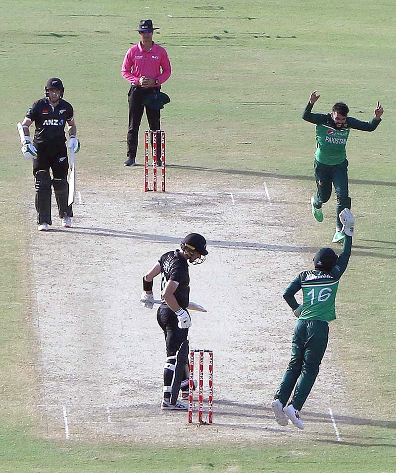 Pakistani bowler Shadab Khan celebrates after taking the wicket of New Zealand's batsman Will Young during 5th and final One-Day International (ODI) cricket match between Pakistan and New Zealand teams at the National Stadium