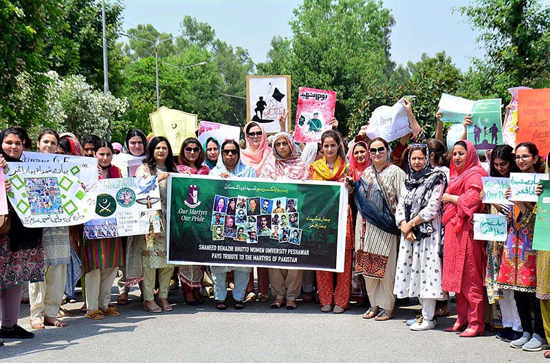 Participants holding solidarity banners during the rally on the occasion of Youm-e-Takreem Shuhada-e-Pakistan at SBBWU
