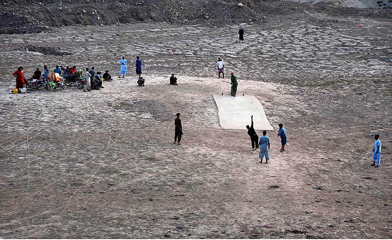Youngsters playing cricket in the dry beds of River Ravi in the Provincial Capital