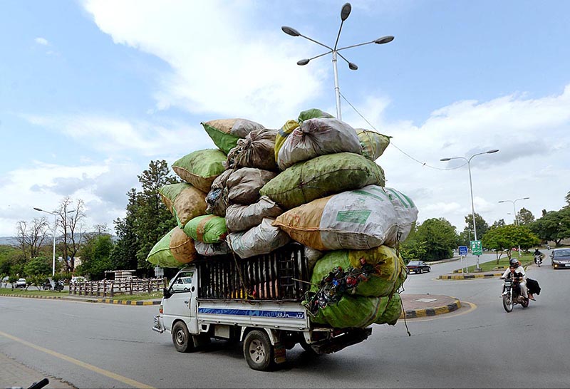 A van is overloaded with scrap sacks on Khushal Khattak Road