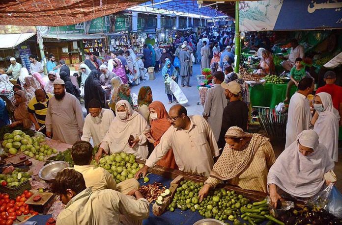 Peoples busy in purchasing vegetables from Wahdat road model Bazar in Provincial Capital City