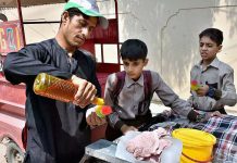 Students buy Ice balls from a roadside vendor