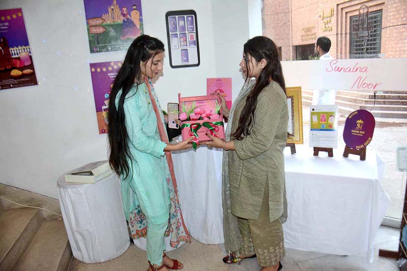 Arts student displaying her stuff during art exhibition at Alhamra Arts Council