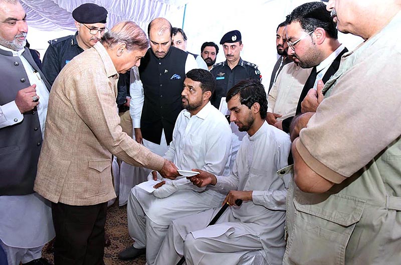 Prime Minister Muhammad Shehbaz Sharif distributes cheques among the employees of Radio Pakistan Peshawar who got injured during attack on Radio Pakistan
