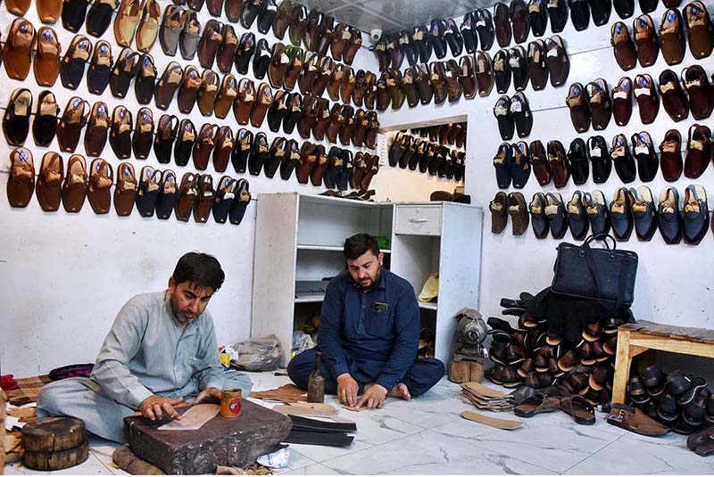 Cobblers preparing traditional shoes (Peshawari Chappal) at their workplace