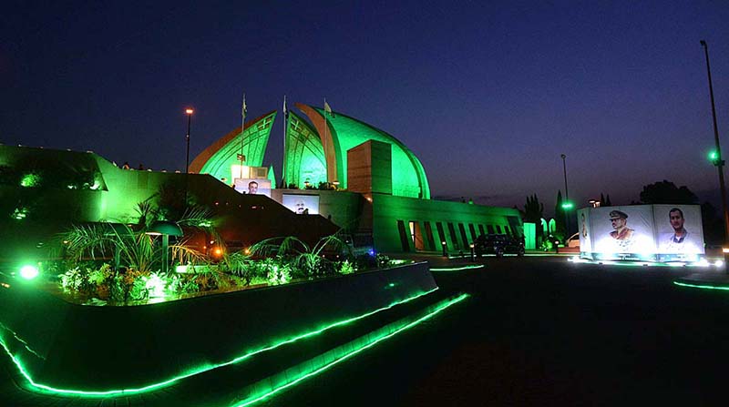People lit up candles to show solidarity with the families of martyrs at the Pakistan Monument, illuminated with green lights in connection with observing Youm-e-Takreem-e-Shuhada-e-Pakistan
