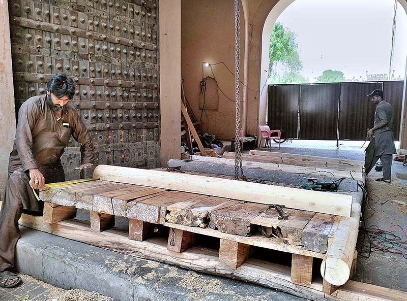 The workers engaged in the restoration work of the historic Shahi Fort’s Roshnai Gate