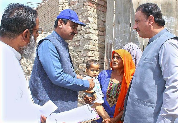 Commissioner Larkana Ghanwar Ali Laghari along with DHO Syed Athar Ali Shah review the performance of the polio teams during one-week polio campaign at village Mewal Kot Ratodero