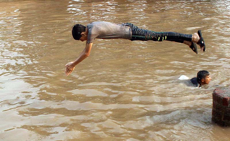 A youngster jumps into canal to beat the heat