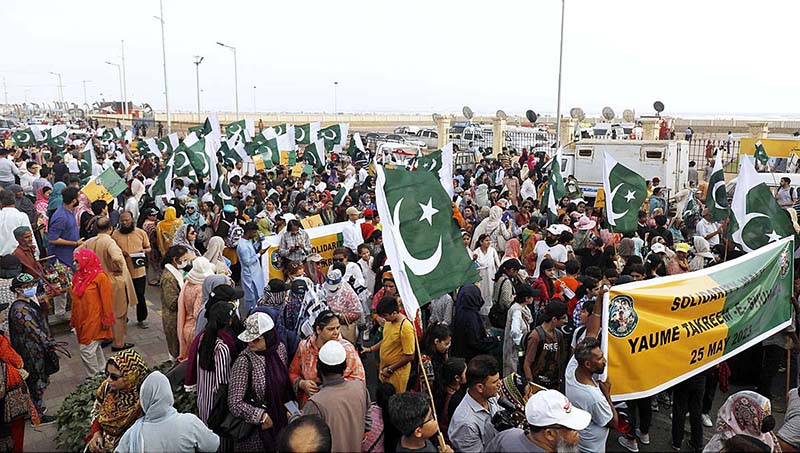 Civil society activists participating in a rally in solidarity with armed forces at Sea view area on the occasion of Youm-e-Shuhda-e-Takreem-e-Pakistan