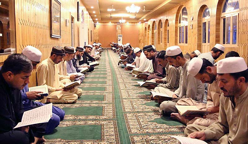 People reciting Holy Quran during cermoy on the occasion of Youm-e-Takreem-e-Shuhada-e-Pakistan at FCNA