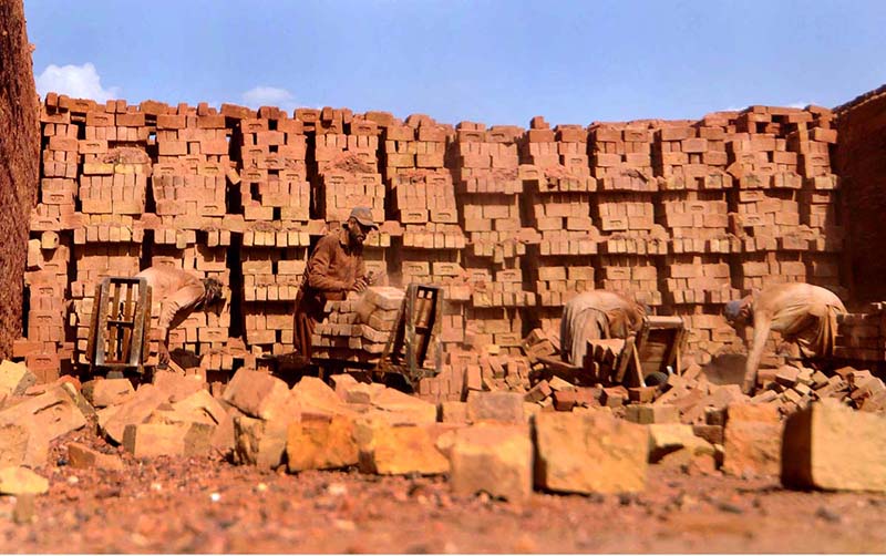 Labourers busy working in local brick kiln during hot weather at outskirts of the Federal Capital