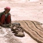 Labourer is busy making raw bricks at a local kiln