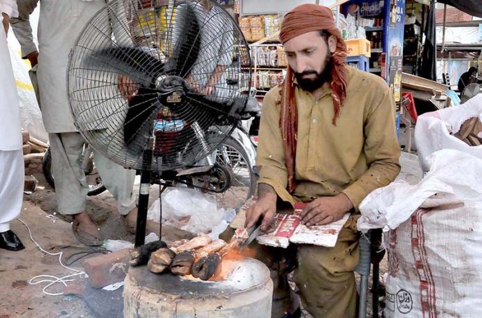 A vendor cleans sacrificial animal trotters (Paya) for customers on the 2nd day of Eid Ul Azha at his workplace