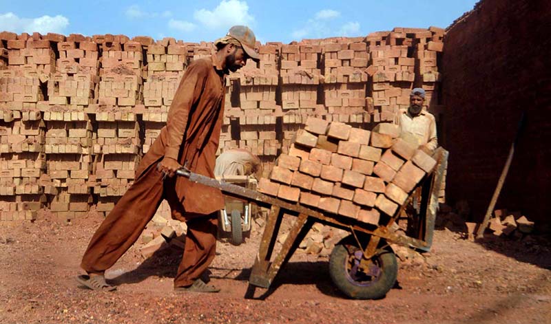 Labourers busy working in local brick kiln during hot weather at outskirts of the Federal Capital